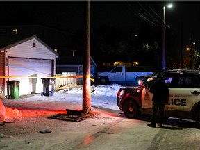 Crime scene tape surrounds an area behind a house where Edmonton Police Service officers are investigating a suspicious death at a home near 67 Street and 127 Avenue in Edmonton, on Friday, Dec. 3, 2021. Photo by Ian Kucerak