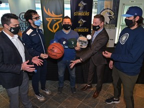 Edmonton sports teams representatives, from left, the Elks Derek Yeomans Director of Ticket Sales and Services, FC Edmonton Head of Partnership Josh Alexander, Javier Salazar from Kids Up Front, the Stingers President Reed Clarke and the Riverhawks pitching coach Ethan Elias, announced the Ultimate Fan Pass. One ticket that will let fans attend games of all four teams in Edmonton, December 6, 2021. Ed Kaiser/Postmedia