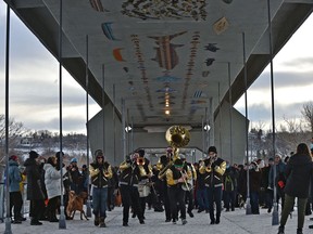 The Brass Tactics band performs as the Cloverdale and Riverdale communities are once again reconnected as participants celebrate the opening of the walking deck on the Tawatinâ Bridge on Sunday, Dec. 12, 2021. Users of the shared-use path across the river can view more than 400 art installations on the bridge ceiling.