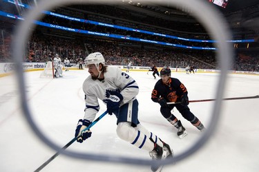 Edmonton Oilers' Ryan Nugent-Hopkins (93) chases Toronto Maple Leafs' Justin Holl (3) during first period NHL action at Rogers Place in Edmonton, on Tuesday, Dec. 14, 2021.