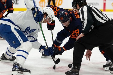 Edmonton Oilers' Connor McDavid (97) faces off against  Toronto Maple Leafs' John Tavares (91) during first period NHL action at Rogers Place in Edmonton, on Tuesday, Dec. 14, 2021.