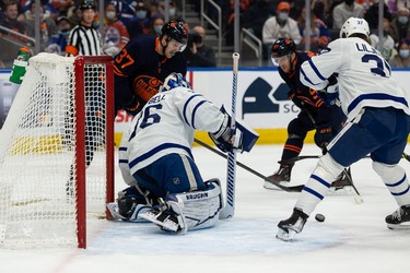 Toronto Maple Leafs' goaltender Jack Campbell (36) stops Edmonton Oilers' Warren Foegele (37) during first period NHL action at Rogers Place in Edmonton, on Tuesday, Dec. 14, 2021.