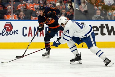 Edmonton Oilers' Kyle Turris (8) shoots past Toronto Maple Leafs' Morgan Reilly (44) during first period NHL action at Rogers Place in Edmonton, on Tuesday, Dec. 14, 2021.