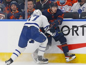 Toronto Maple Leafs defencemen Tim Liljrgren (37) checks Edmonton Oilers forward Kailer Yamamoto (56) at Rogers Place on Tuesday, Dec. 14, 2021.
