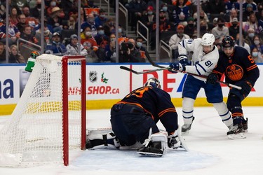 Edmonton Oilers' goaltender Mikko Koskinen (19) stops Toronto Maple Leafs' John Tavares (91) during second period NHL action at Rogers Place in Edmonton, on Tuesday, Dec. 14, 2021.
