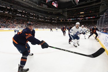 Edmonton Oilers' Tyson Barrie (22) reaches for a puck as Toronto Maple Leafs' Pierre Engvall (47) gives chase during second period NHL action at Rogers Place in Edmonton, on Tuesday, Dec. 14, 2021.