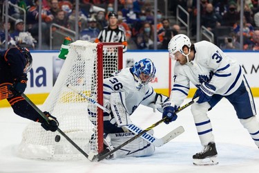 Edmonton Oilers' Warren Foegele (37) is stopped by Toronto Maple Leafs' goaltender Jack Campbell (36) and Auston Matthews (34) during third period NHL action at Rogers Place in Edmonton, on Tuesday, Dec. 14, 2021.