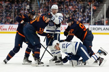 Edmonton Oilers' Darnell Nurse (25), Jesse Puljujarvi (13) and Connor McDavid (97) battle Toronto Maple Leafs' Michael Bunting (58) and Ondrej Kase (25) during third period NHL action at Rogers Place in Edmonton, on Tuesday, Dec. 14, 2021.
