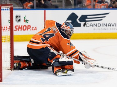 Edmonton Oilers' goaltender Stuart Skinner (74) makes a stick save on the Columbus Blue Jackets during second period NHL action at Rogers Place in Edmonton, on Thursday, Dec. 16, 2021.