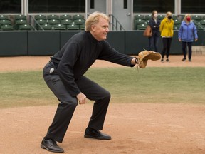 Dr. Randy Gregg gets behind the plate after announcing the the newest baseball team in Edmonton, The Riverhawks, a baseball club, which will play out of RE/MAX Field in the n the West Coast League, on Sept. 15, 2020 in Edmonton.