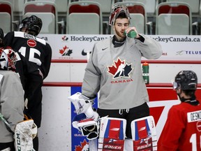 Goalie Sebastian Cossa pauses for a water break during a practice at the Canadian World Junior Hockey Championships selection camp in Calgary on Thursday, Dec. 9, 2021.