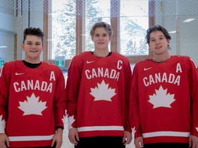 From left to right, Cole Perfetti, Kaiden Guhle and Jake Neighbours of Team Canada pose after practice at the Fenlands Banff Recreation Centre on Dec. 20, 2021, after being named to the leadership group for the upcoming world junior hockey championship in Edmonton and Red Deer starting on Boxing Day.