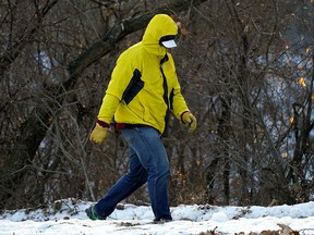 A man cautiously walks on an ice covered walkway on River Valley Road in Edmonton on Thursday December 2, 2021. (PHOTO BY LARRY WONG/POSTMEDIA)