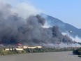 Smoke rises above the town after wildfires forced its residents to evacuate, in Lytton, British Columbia, June 30, 2021.