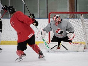 Team Canada goalie Brett Brochu makes a save during practice at the Fenlands Banff Recreation Centre on Dec. 20, 2021.