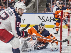 Goaltender Mikko Koskinen (19) of the Edmonton Oilers tracks a loose puck next to Emil Bemstrom of the Columbus Blue Jackets at Rogers Place in Edmonton on March 7, 2020.