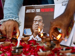 People light oil lamps next to roses to express their condolences to the people of Sri Lanka, following the lynching of the Sri Lankan manager of a garment factory after an attack on the factory in Sialkot, in Karachi, Pakistan December 5, 2021.