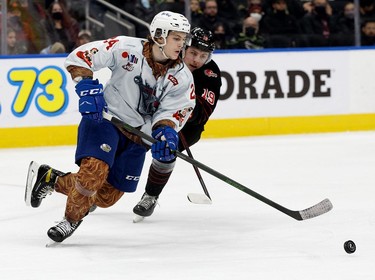 The Edmonton Oil Kings' Logan Dowhaniuk (24) battle the Moose Jaw Warriors' Martin Rysavy (19) during second period WHL action at Rogers Place, in Edmonton Saturday Dec. 4, 2021.