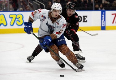 The Edmonton Oil Kings' Logan Dowhaniuk (24) battle the Moose Jaw Warriors' Martin Rysavy (19) during second period WHL action at Rogers Place, in Edmonton Saturday Dec. 4, 2021.