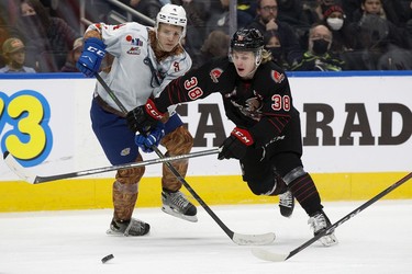 The Edmonton Oil Kings' Kaiden Guhle (4) battle the Moose Jaw Warriors' Ryder Korczak (38) during second period WHL action at Rogers Place, in Edmonton Saturday Dec. 4, 2021.