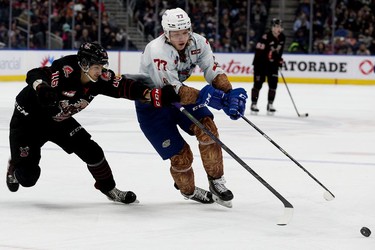 The Edmonton Oil Kings' Jakub Demek (77) battle the Moose Jaw Warriors' Maximus Wanner (16) during first period WHL action at Rogers Place, in Edmonton Saturday Dec. 4, 2021.