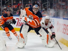 Goaltender Stuart Skinner (No. 74) of the Edmonton Oilers battles against Dylan Gambrell (No. 27) of the Ottawa Senators during the first period at Rogers Place on January 15, 2022.