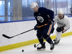 Adam Cracknell (27) battles Ryan Stanton (5) during an Edmonton Oilers training camp scrimmage in Edmonton on Jan. 7, 2021.