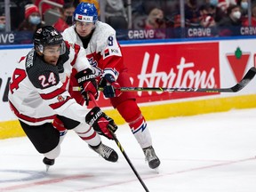 Team Canada’s Justin Sourdif (24) battles Team Czechia’s David Moravec (8) during third period IIHF World Junior Championship action at Rogers Place in Edmonton, on Sunday, Dec. 26, 2021.