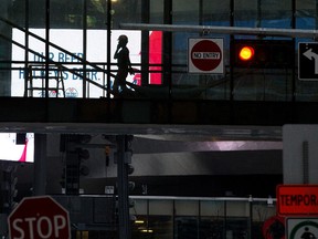 A construction worker makes their way through an under construction pedestrian walkway in Edmonton's Ice District on Thursday, Jan. 13, 2022. Photo by David Bloom