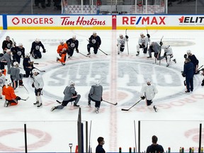 The Edmonton Oilers stretch during practice at Rogers Place in Edmonton on Monday, Jan. 24, 2022.