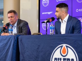 Edmonton Oilers general manager Ken Holland, left, and forward Evander Kane speak at a press conference announcing the player's signing at Rogers Place in Edmonton on Friday, Jan. 28, 2022.