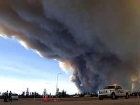 RCMP officers monitor the Fort McMurray wildfire, on May 7, 2016.