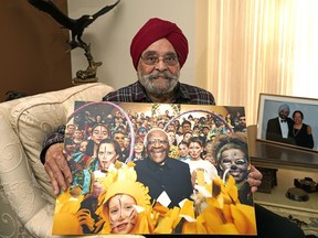 Gurcharan Bhatia holds a photo of Bishop Desmond Tutu at his home in Edmonton on January 4, 2022. Bhatia and his late wife Jiti were instrumental in bringing Tutu to Edmonton in 1998 to attend the International Human Rights Conference. Tutu died at the age of 90 on December 26, 2021.