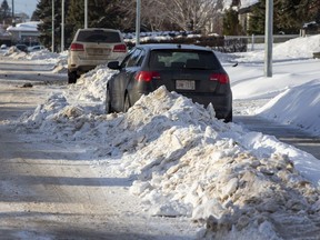 Windrows have been graded up in front of homes on Wednesday, Jan. 12, 2022 in north Edmonton.