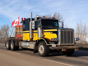 A convoy of trucks, cars and pickup trucks heads east on Highway 16A from Devon to convoy to the Alberta Legislature in support of the national Freedom Convoy 2022 in Edmonton, on Saturday, Jan. 29, 2022.