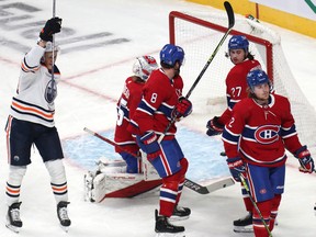 Edmonton Oilers right wing Jesse Puljujarvi (13) (left) celebrates a goal by linemate Leon Draisaitl (not pictured) against Montreal Canadiens goaltender Sam Montembeault (35) at Bell Centre on Saturday, Jan. 29, 2022.