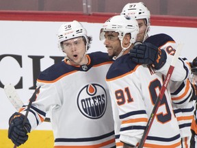 Edmonton Oilers' Evander Kane (91) celebrates his goal with teammates Kailer Yamamoto (56) and Connor McDavid (97) against the Montreal Canadiens, in Montreal on Saturday, Jan. 29, 2022.