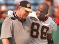 B.C. Lions wide receiver Larry Thompson chats with Hamilton Tiger-Cats head coach Don Sutherin  at Ivor Wynne Stadium in Hamilton in this file photo taken on Aug. 2, 1997.