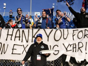 Happy Edmonton owner Tom Fath (centre) celebrates a win and the end of a season with members of the FC Edmonton Supporters Group after a NASL soccer game between FC Edmonton and the Atlanta Silverbacks at Clarke Stadium in Edmonton, Alta., on Sunday, Nov. 2, 2014. Edmonton won 2-1.