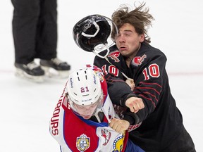 Edmonton Oil Kings captain Jake Neighbours and Moose Jaw Warriors captain Daemon Hunt fight on Tuesday, Jan. 25, 2022 in Edmonton.