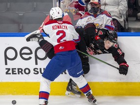 Edmonton Oil Kings' Carter Kowalyk checks Moose Jaw Warriors' Atley  Calvert on Tuesday, Jan. 25, 2022 in Edmonton.