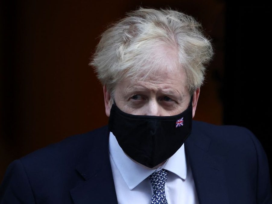 British Prime Minister Boris Johnson walks outside Downing Street in London, Jan. 12, 2022.