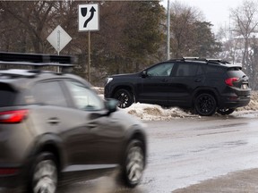 An SUV is seen stranded on a median windrow near 10550 Ellerslie Road, in Edmonton on Monday, Jan. 17, 2022.