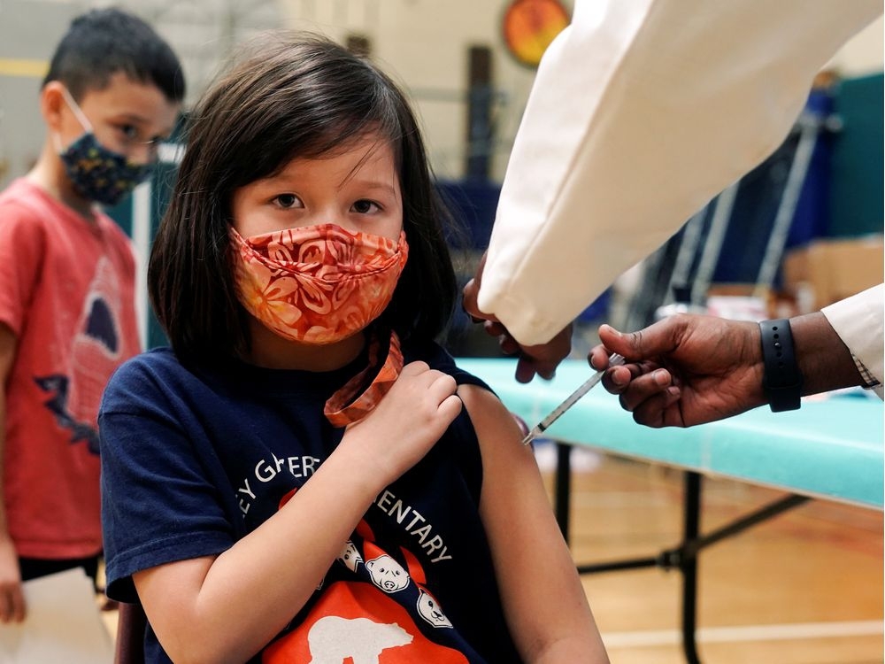 Maya Griesemer, 7, receives a first dose of the Pfizer-BioNTech coronavirus disease (COVID-19) vaccine from Seattle Public Schools' school-day clinic at Bailey Gatzert Elementary in Seattle, Washington, U.S., November 8, 2021.