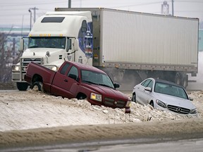 Freezing rain and snow created havoc on Edmonton area city streets and highways on Jan. 13, 2022. Multiple vehicles ended up in the ditch, like these two on Sherwood Park Freeway east of 50 Street.