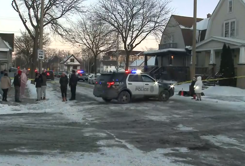 Police at the scene in Milwaukee after four men and one woman were found fatally shot in a home on Sunday, Jan. 23, 2022.