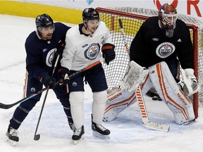 Cody Ceci (5), Zach Hyman (18) and goalie Mikko Koskinen (19) take part in an Edmonton Oilers practice at Rogers Place in Edmonton on Wednesday, Jan. 19, 2022. Photo by David Bloom