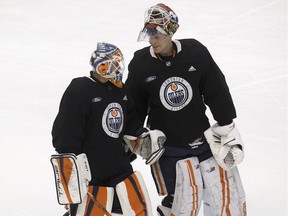Ilya Konovalov (34) and Mikko Koskinen (19) take part in an Edmonton Oilers practice at Rogers Place in Edmonton on Wednesday, Jan. 19, 2022.