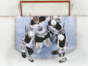 Teammates congratulate goaltender Mikko Koskinen (19) of the Edmonton Oilers following a 4-3 win against the Florida Panthers at FLA Live Arena on Saturday, Feb. 26, 2022, in Sunrise, Fla.