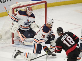 Ottawa Senators left wing Tim Stützle (18) scores the winning goal against Edmonton Oilers goalier Mikko Koskinen (19) in overtime at Canadian Tire Centre on Sunday, Jan. 31, 2022.